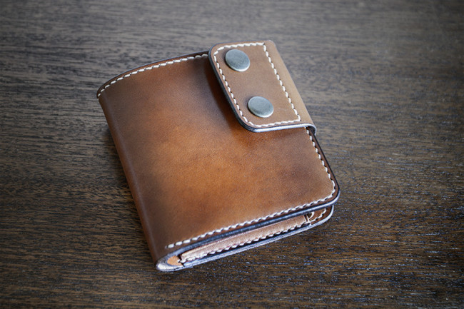 Cartera de cuero modelo Oleiros color marrón, cerrada.